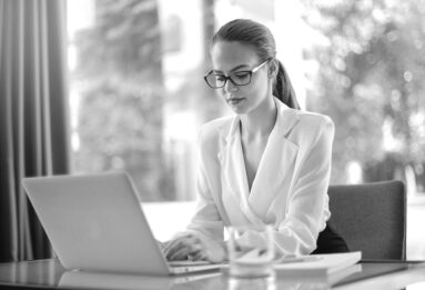 Frau arbeitet am Laptop für Escort Agentur in Berlin